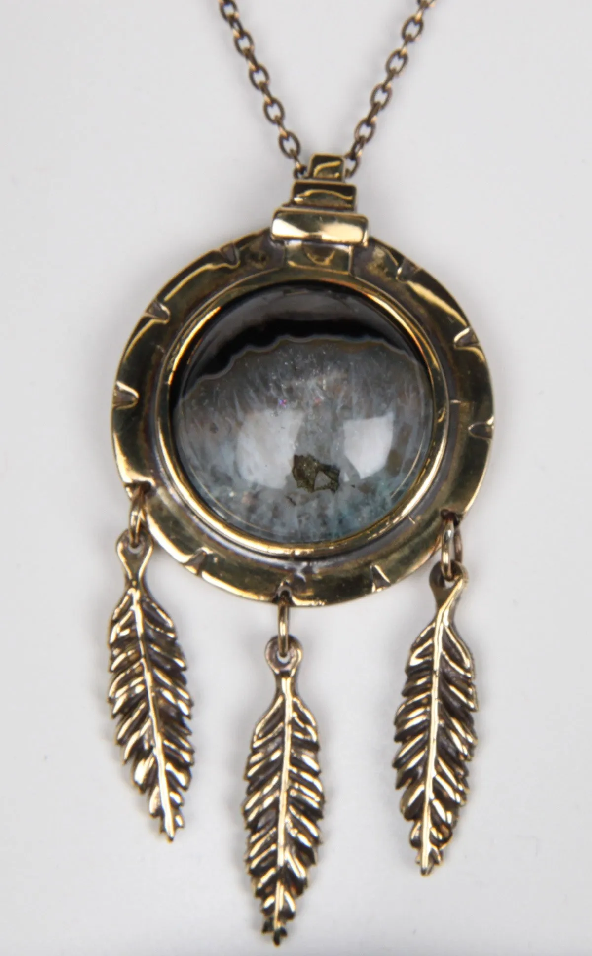 Dial Pendant with Feathers, Brass