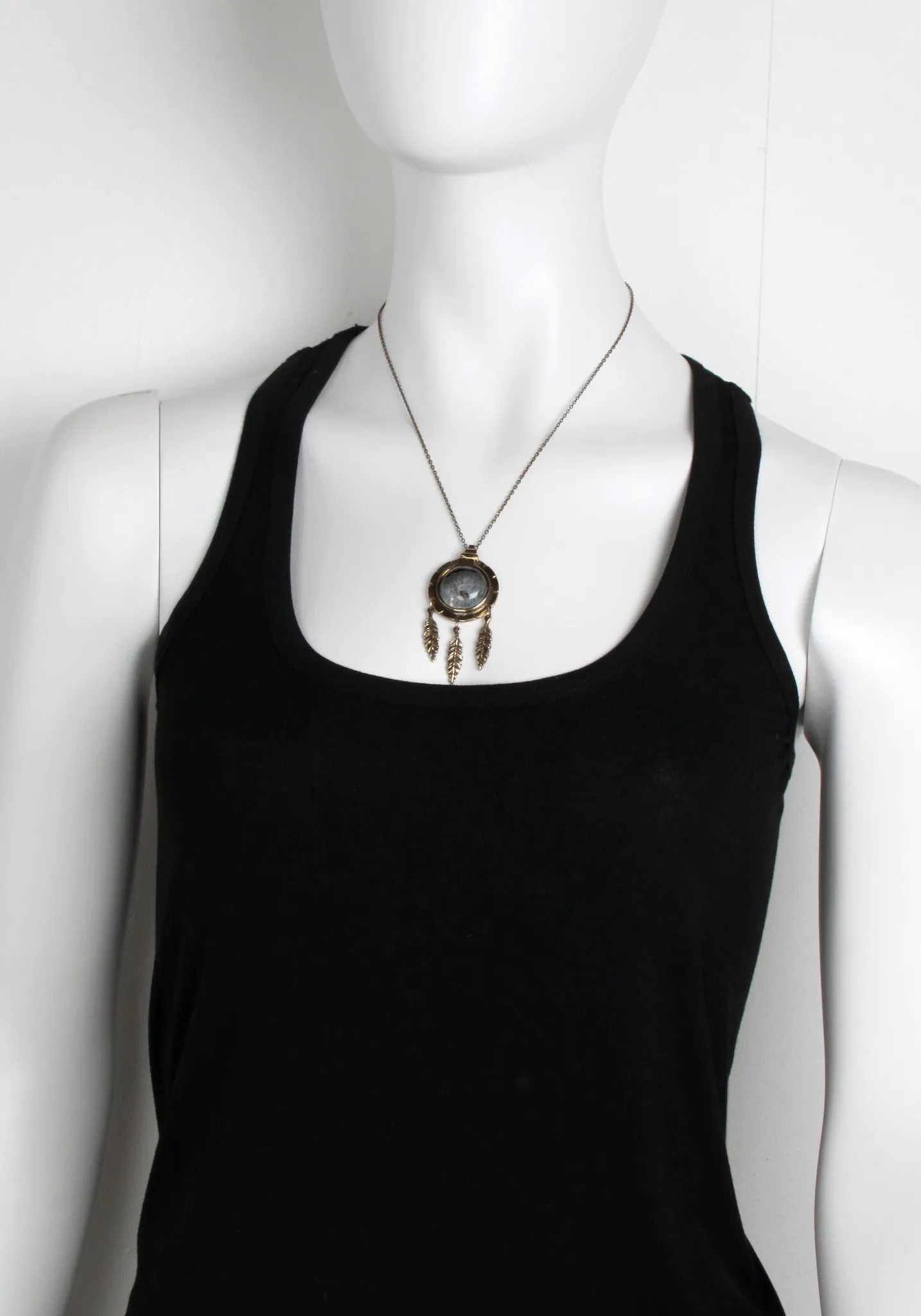 Dial Pendant with Feathers, Brass